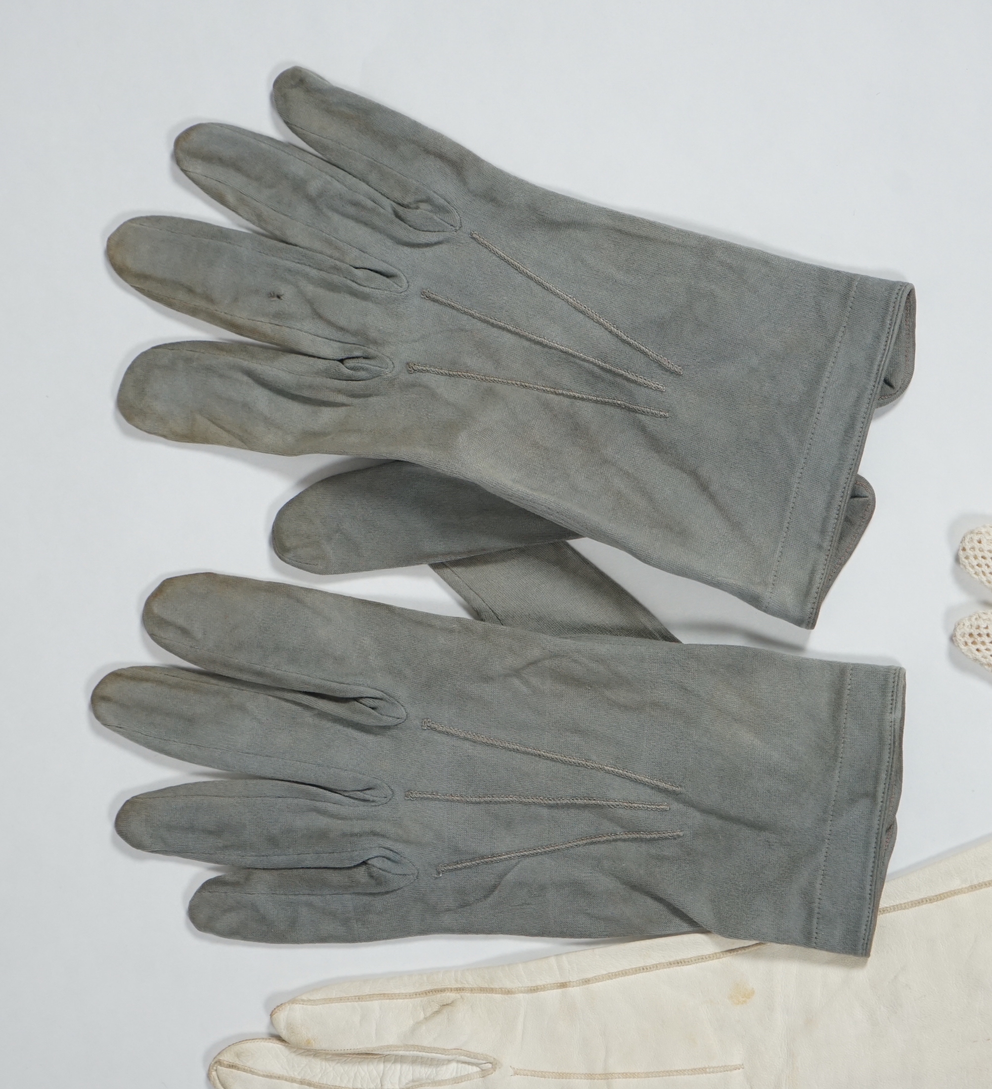 A pair of lady's Hermès skin gloves, boxed and three other pairs of gloves